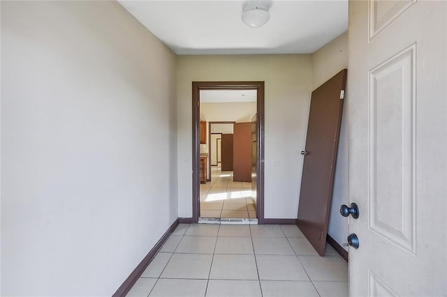 hall featuring light tile patterned floors