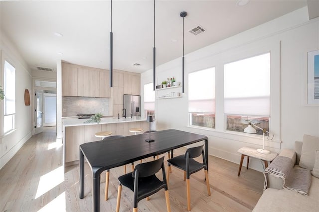 dining room with light wood-type flooring