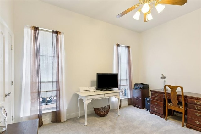 office area with ceiling fan and light carpet