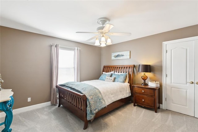 bedroom with light carpet and ceiling fan