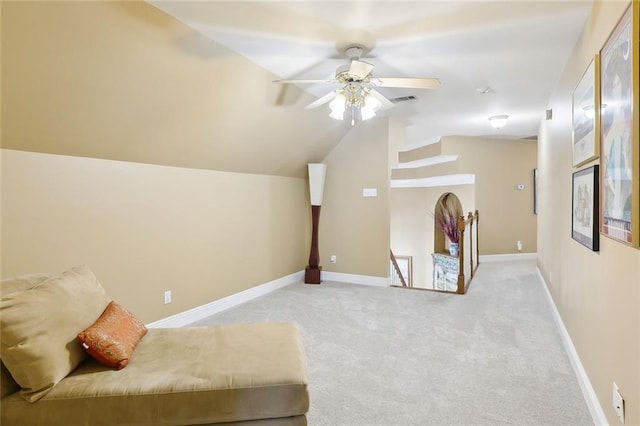 unfurnished room featuring ceiling fan, light colored carpet, and lofted ceiling