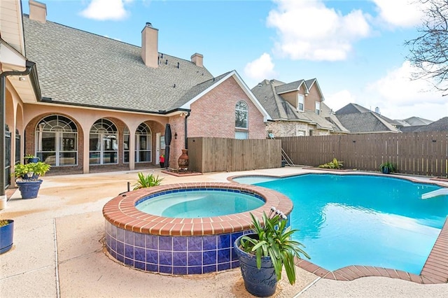 view of swimming pool with a patio area and an in ground hot tub