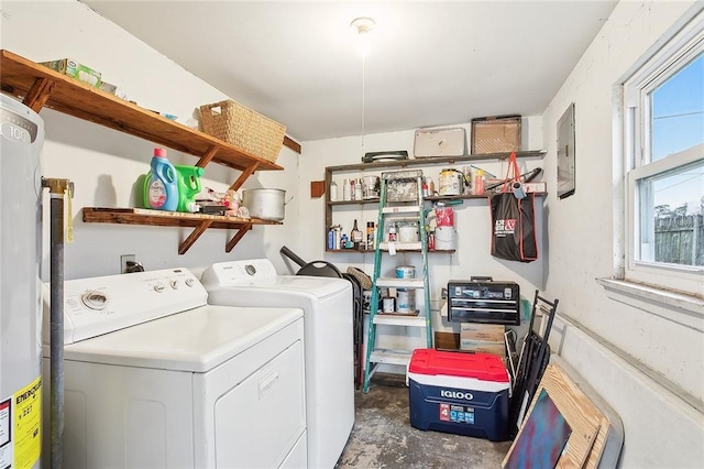 washroom with washing machine and dryer, water heater, and electric panel