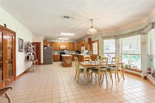 330 Saint Nicholas St, Luling, LA 70070 - dining space with a textured ceiling, light tile patterned flooring, baseboards, and visible vents