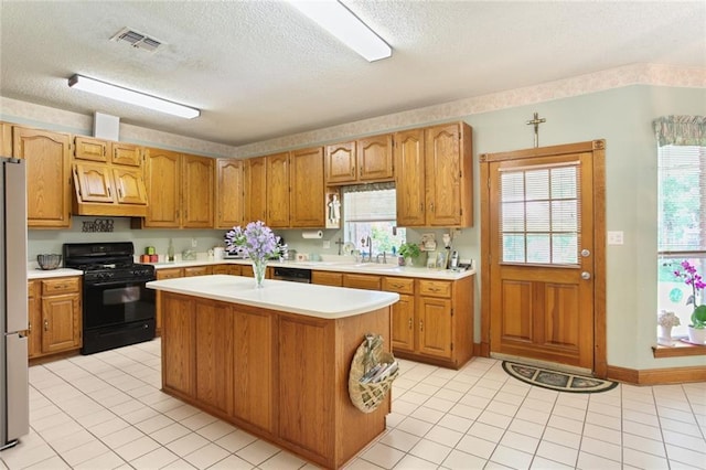 330 Saint Nicholas St, Luling, LA 70070 - kitchen with light countertops, a sink, black range with gas stovetop, and visible vents