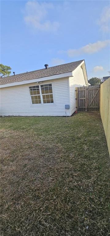 rear view of house with a lawn