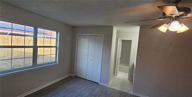 unfurnished bedroom featuring ceiling fan, a closet, and a textured ceiling