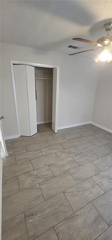 unfurnished bedroom with ceiling fan, a closet, and a textured ceiling