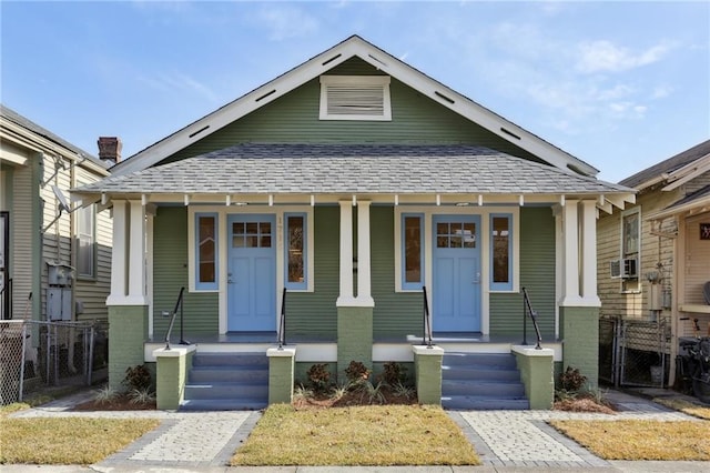 bungalow with a porch and cooling unit