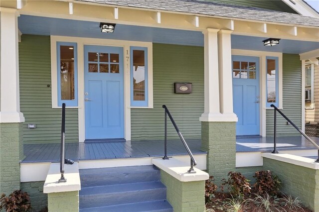 doorway to property featuring a porch