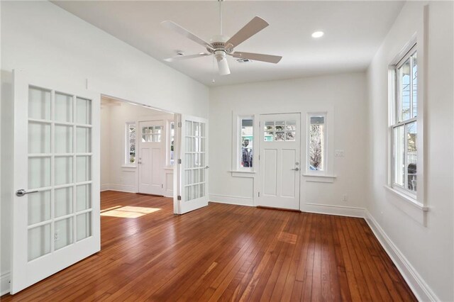 foyer entrance with hardwood / wood-style floors, ceiling fan, and french doors