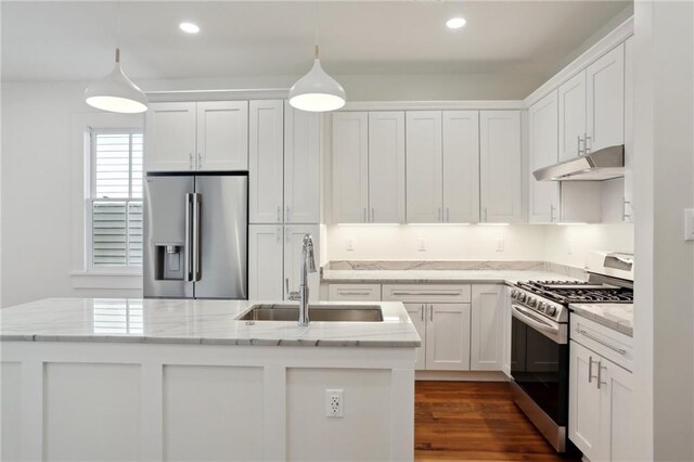 kitchen featuring white cabinetry, pendant lighting, a kitchen island with sink, and appliances with stainless steel finishes