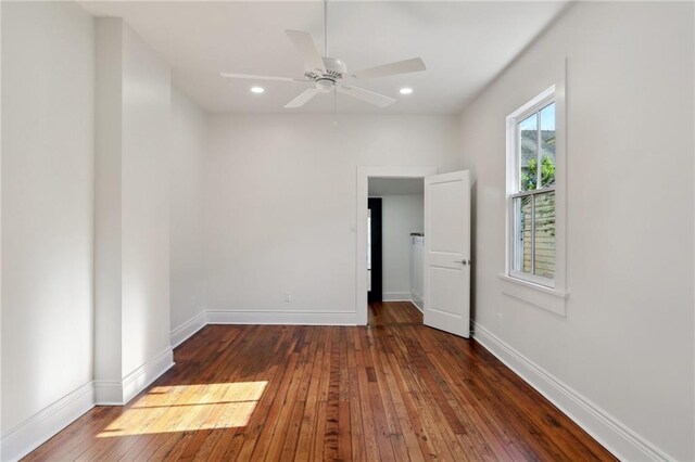 interior space featuring ensuite bathroom, dark hardwood / wood-style floors, and ceiling fan