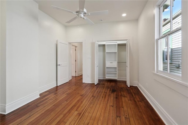 unfurnished bedroom with a closet, dark hardwood / wood-style floors, and ceiling fan