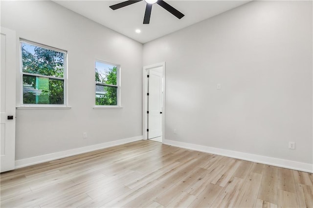 unfurnished room with ceiling fan and light wood-type flooring