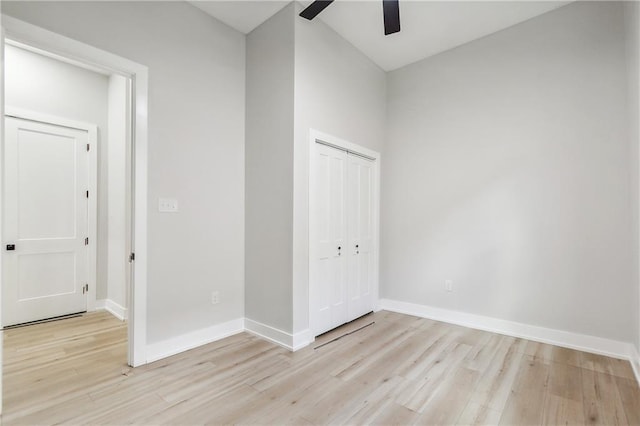 unfurnished bedroom featuring ceiling fan, light wood-type flooring, and a closet