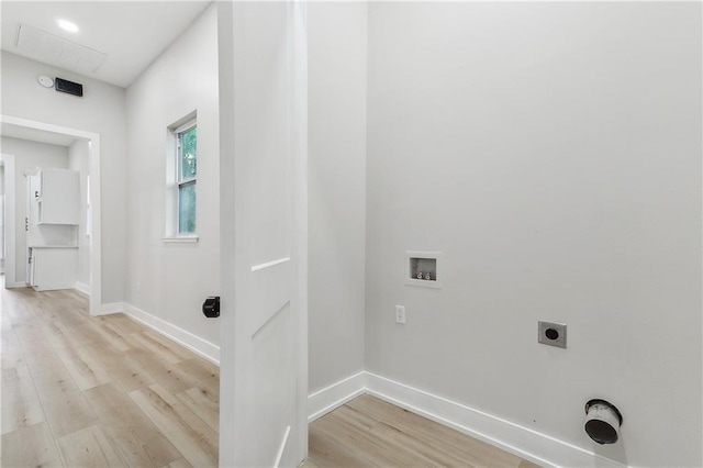 laundry room with hookup for a washing machine, hookup for an electric dryer, and light hardwood / wood-style floors