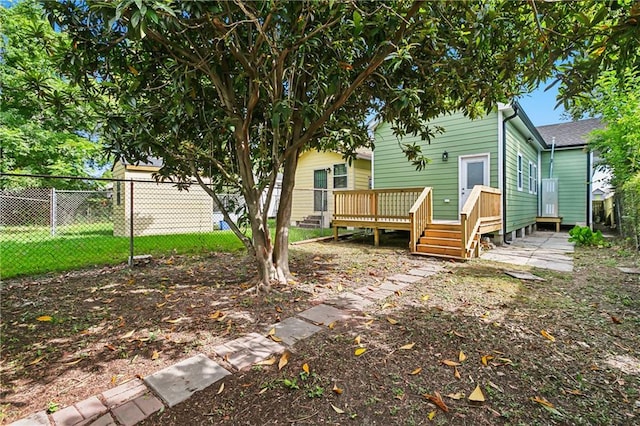 rear view of house featuring a wooden deck