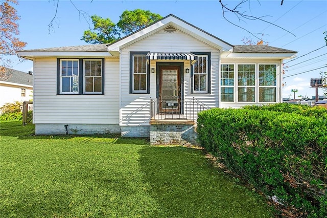 bungalow-style house with a front lawn