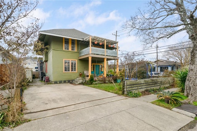 view of front of house with a balcony and covered porch