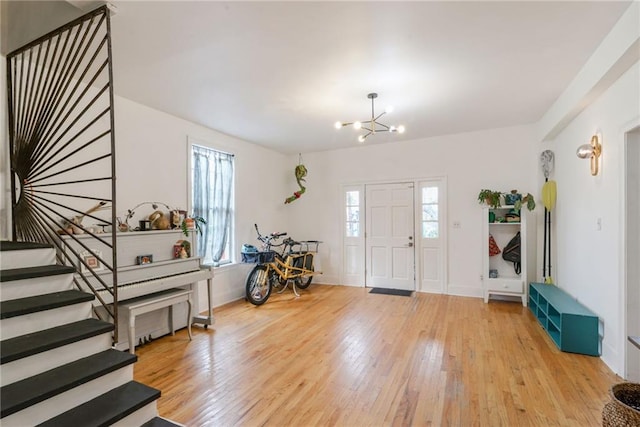 foyer with a chandelier and light hardwood / wood-style flooring