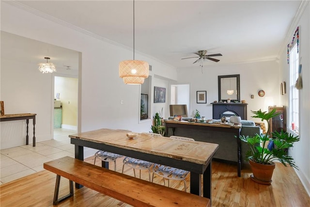 dining area featuring crown molding, ceiling fan, and light tile patterned flooring