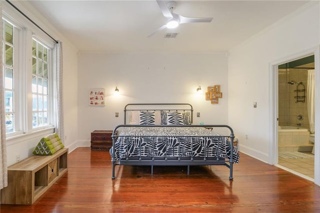 bedroom with crown molding, wood-type flooring, and ensuite bathroom