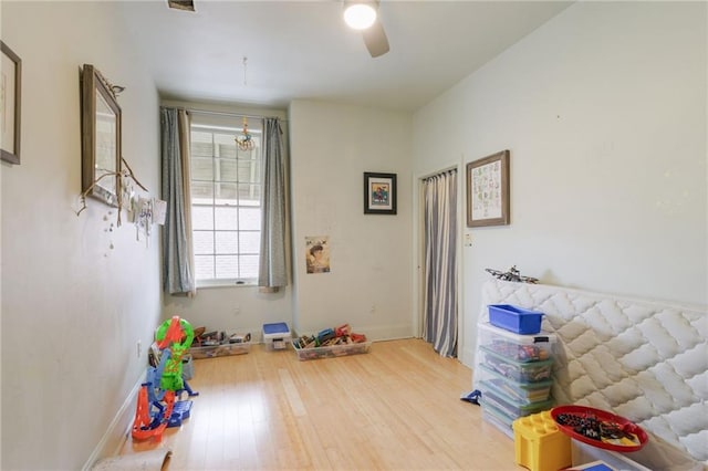 game room with hardwood / wood-style flooring and ceiling fan