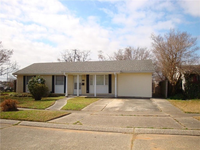 ranch-style house with covered porch, roof with shingles, and fence