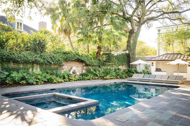 view of pool featuring an in ground hot tub, outdoor lounge area, and a patio