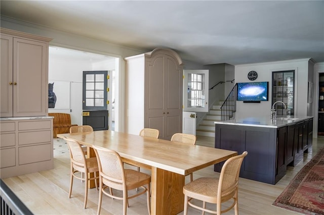 dining room with sink and light hardwood / wood-style floors