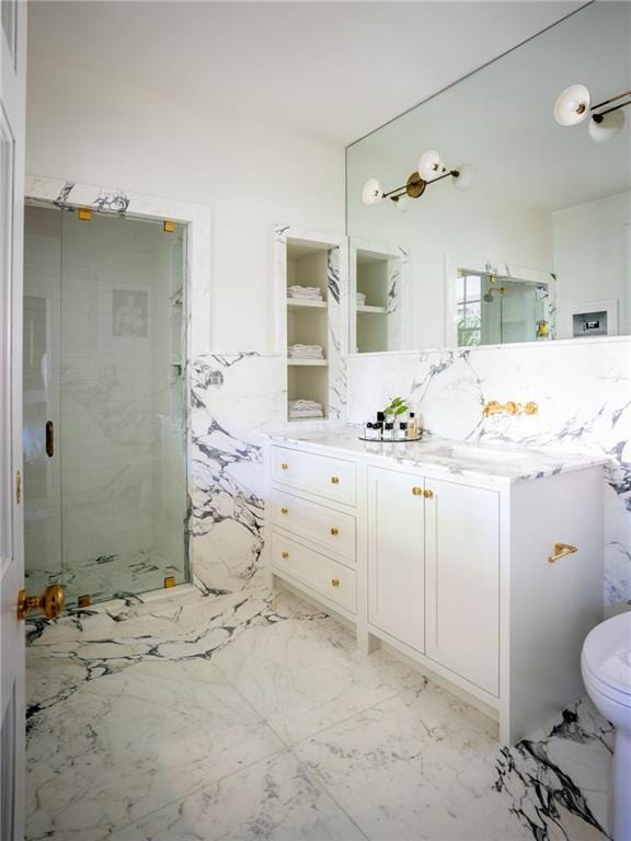 bathroom featuring vanity, toilet, and a shower with door