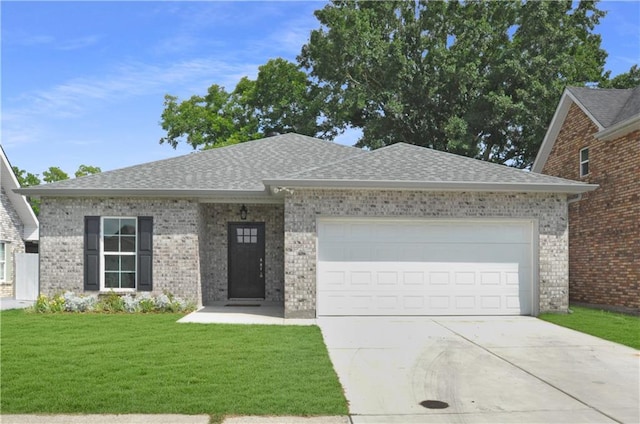 view of front of home with a garage and a front lawn