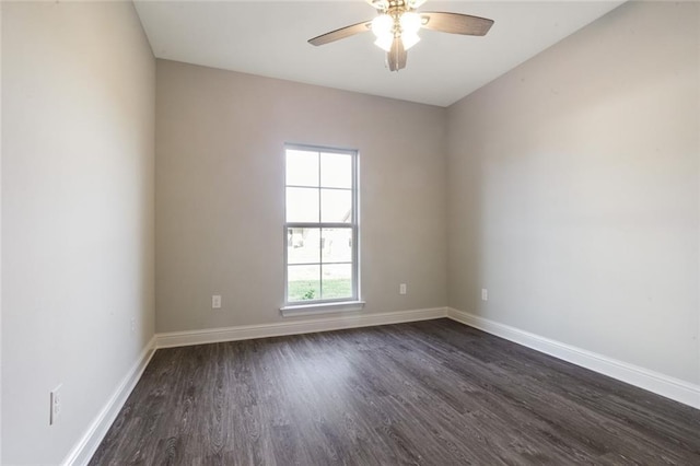 spare room featuring dark hardwood / wood-style flooring and ceiling fan