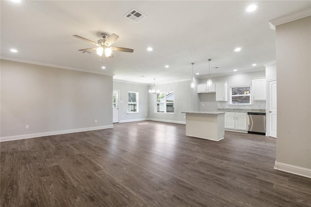 unfurnished living room with crown molding, sink, ceiling fan with notable chandelier, and dark wood-type flooring