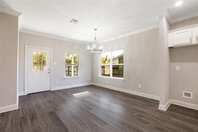 unfurnished dining area featuring dark hardwood / wood-style flooring, crown molding, and a chandelier