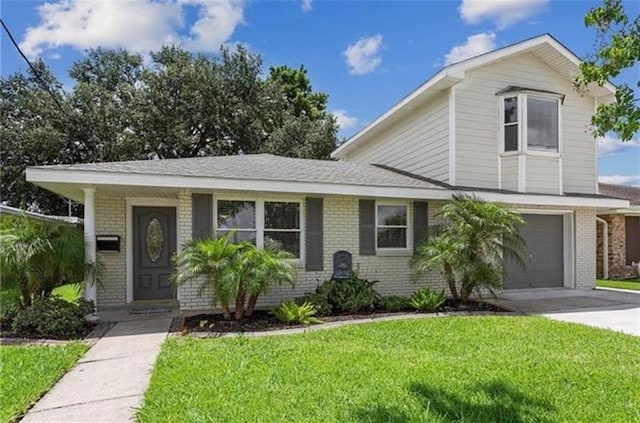 view of front of property with a garage and a front lawn