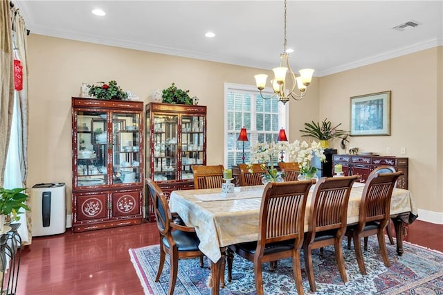 dining room with crown molding, dark hardwood / wood-style floors, and a notable chandelier