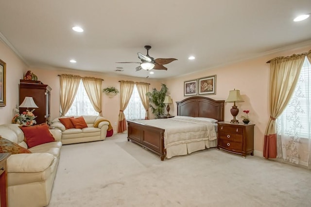 carpeted bedroom with ceiling fan and ornamental molding