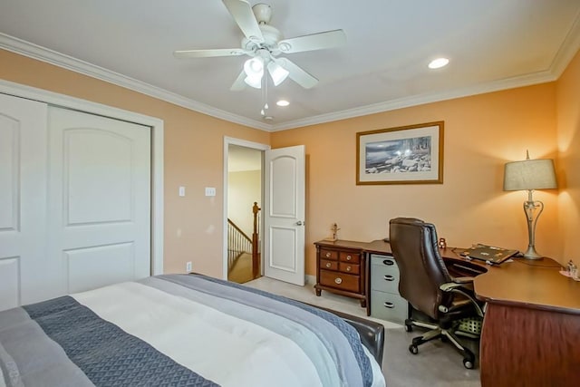 carpeted bedroom featuring crown molding, ceiling fan, and a closet