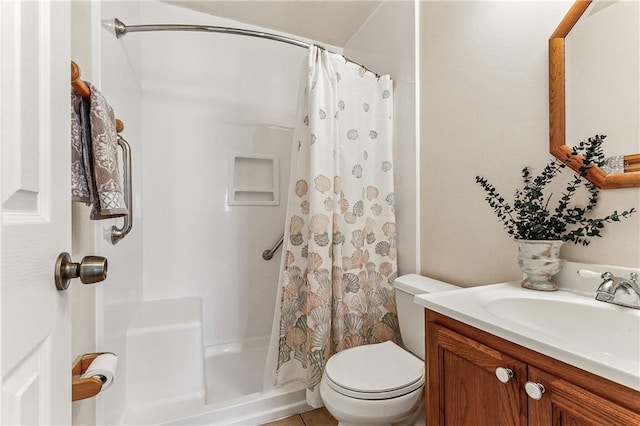 bathroom featuring toilet, vanity, and a shower with shower curtain