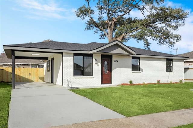 single story home with a front lawn and a carport