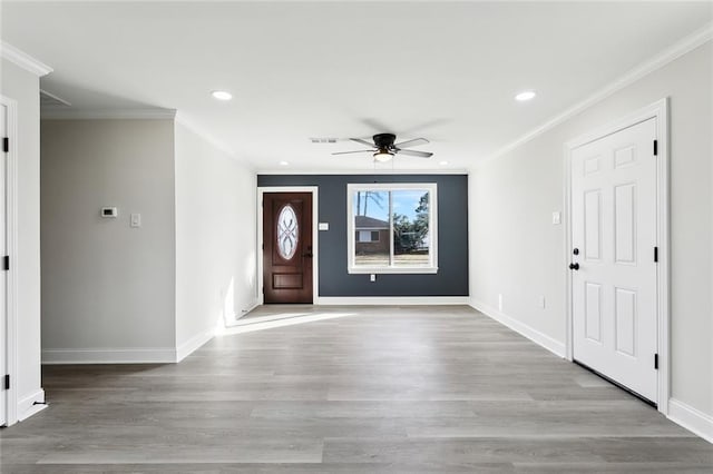 foyer with ornamental molding, ceiling fan, and light hardwood / wood-style flooring