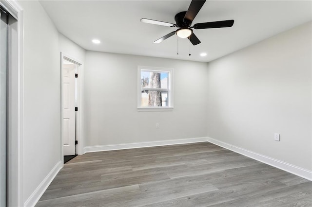 empty room featuring wood-type flooring and ceiling fan