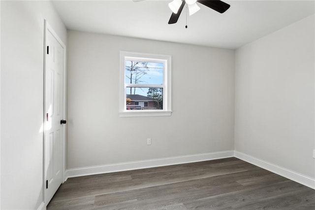 empty room with dark wood-type flooring and ceiling fan