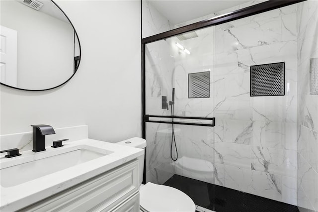 bathroom featuring vanity, toilet, and an enclosed shower