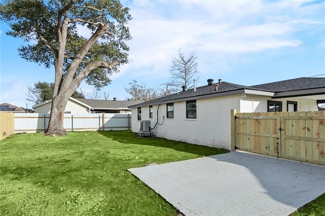 back of property with cooling unit, a yard, and a patio