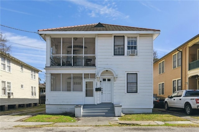 view of front of house featuring cooling unit and a sunroom