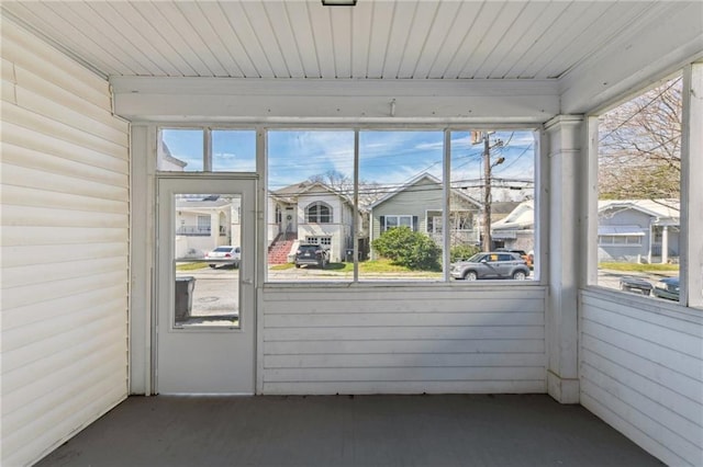 unfurnished sunroom featuring wooden ceiling