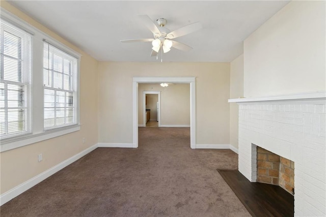 unfurnished living room with dark colored carpet, ceiling fan, and a fireplace